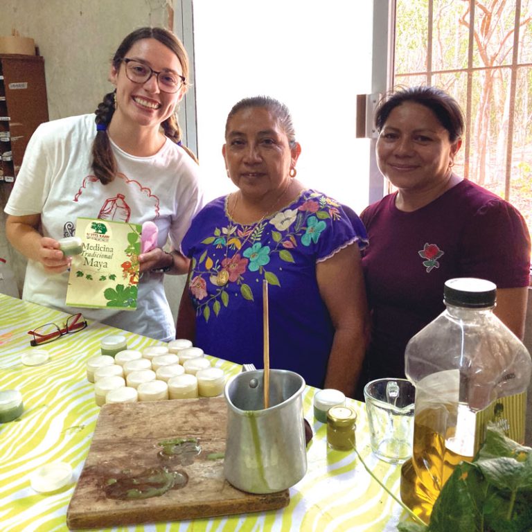 Participant Brinkley Johnson (far left) and two local partners create traditional Mayan herbal products at U Yits Ka’an. 