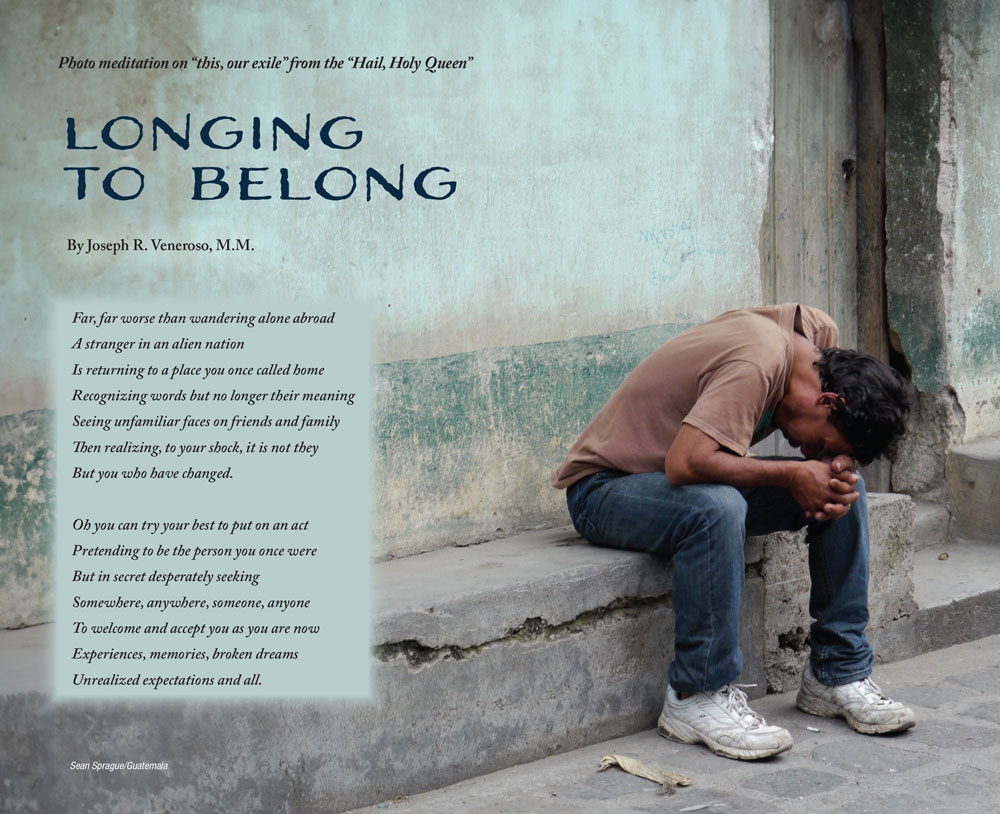 A man sits forlorn on a stone bench, head in his hands by his knees