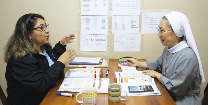 Karla Rojas (left), of the newly formed language school housed at the Maryknoll center, instructs pupil Sister Kang JuJin of Korea in Spanish. (Adam Mitchell/Bolivia) 
