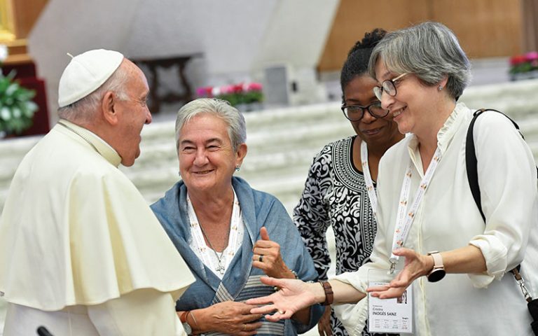 Pope Francis converses with a small group of women members of the Synod of Bishops at the assembly’s session Oct. 6, 2023 at the Vatican. 