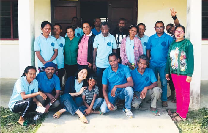 The Community-Based Rehabilitation motivators pose with Maryknoll Sister Hyunjung Kim (bottom row, third from left) outside the Uma Ita Nian (Our Home) clinic. (Courtesy of Hyunjung Kim/East Timor)