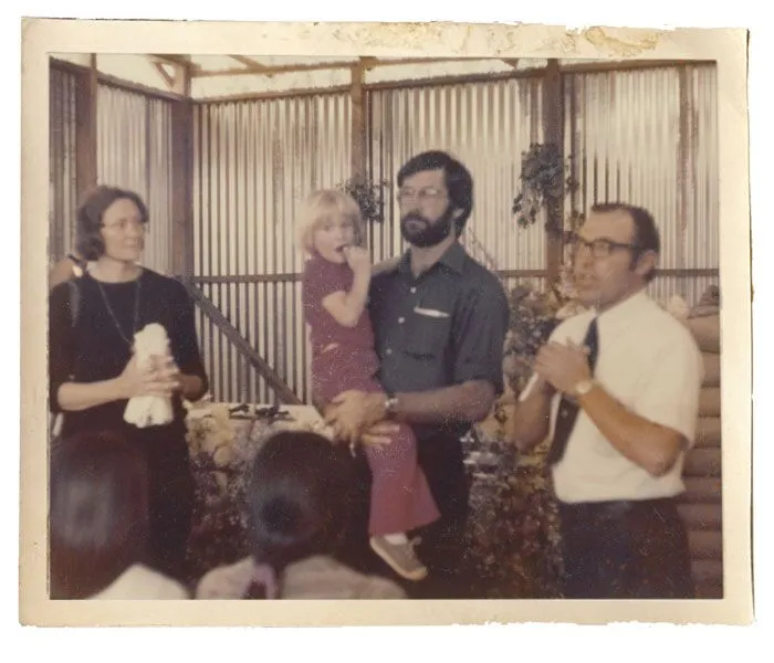 At a memorial Mass in Guatemala City, Phyllis Gauker looks on as a Canadian missionary priest holds Johnny and Maryknoll Brother Robert Butsch addresses the construction workers gathered to attend the service for John. 