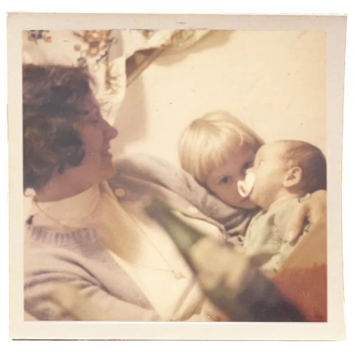 Phyllis Gauker and son Johnny are shown with baby Monica after her baptism, which was officiated by Maryknoll Father William Woods at the plane hangar in Guatemala City. 