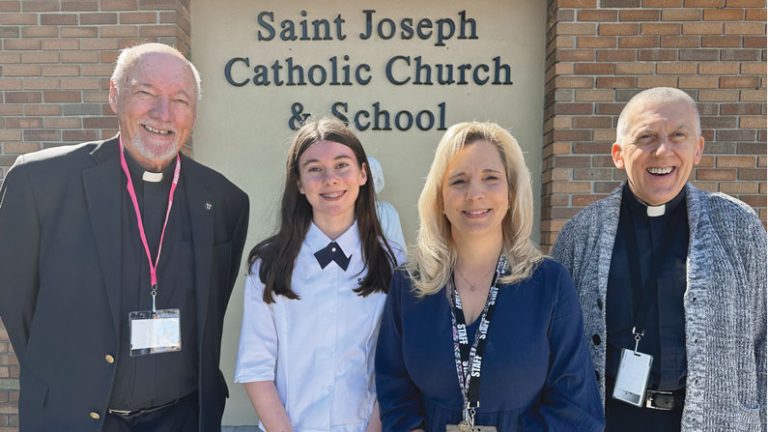 Maryknoll Father Leo Shea (left) presents the Bishop Francis X. Ford Award to Evelyn Keown, first-place winner of Division I of the 2023 Maryknoll Student Essay Contest. With Evelyn are Principal Jennifer Insua and Father Tom LaBo. 