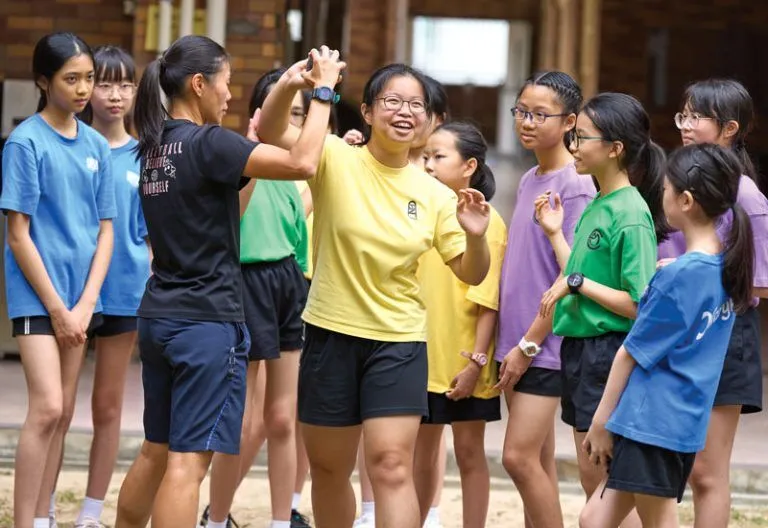 Secondary section students throw the shot during physical education class. MCS offers 64 extracurricular clubs and teams focused on sports, music, service and academics.