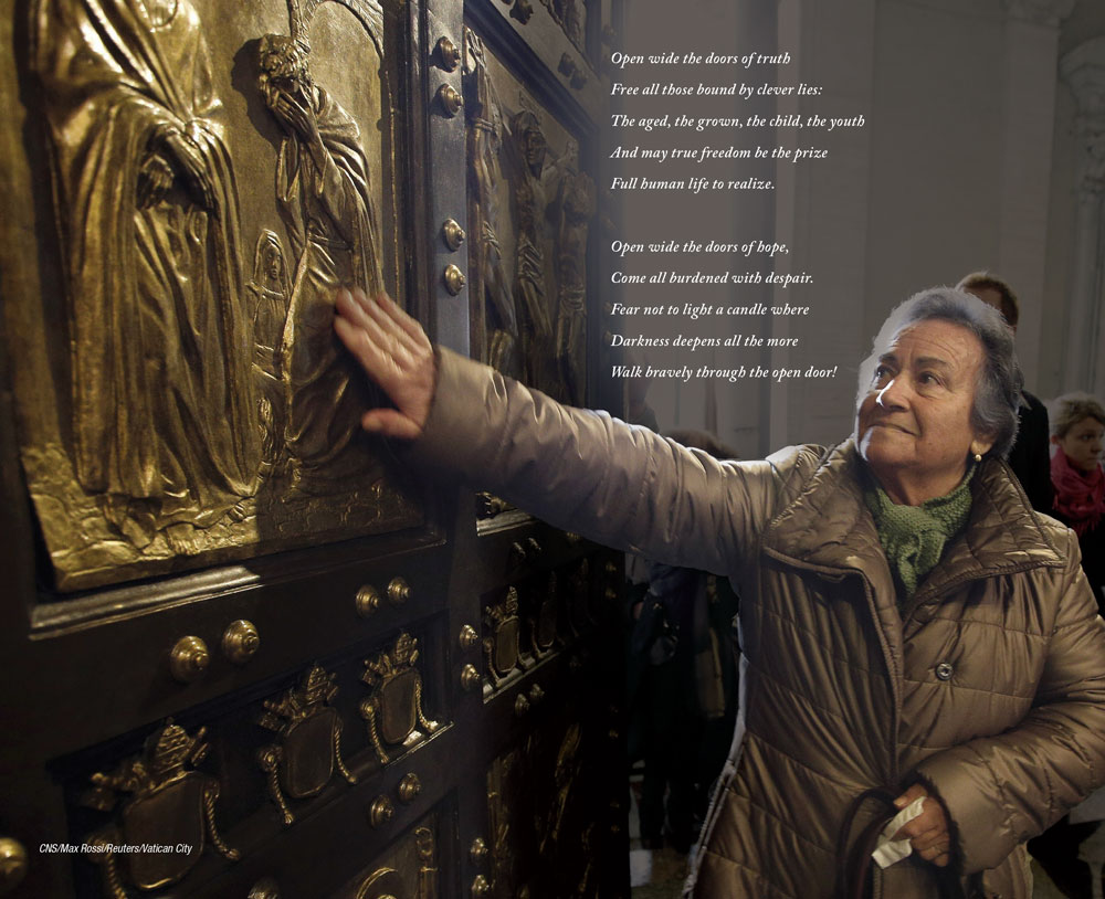 A woman reverently touches the brass relief carving on the doors of a cathedral.