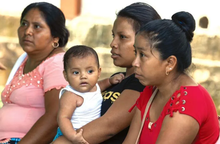 Patients wait to be seen by Sister Daoust at a two-room outpost clinic built next to the Catholic church of the village of Nicá in the department (state) of San Marcos. 