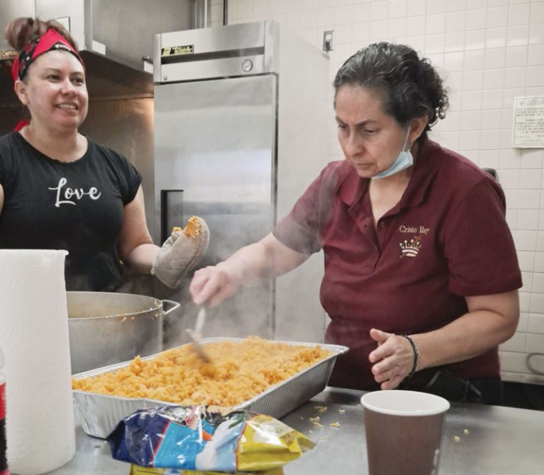 Cristo Rey parishioners Claudia Díaz and Gloria Ibarra (left, right) prepare hot meals for migrants and refugees staying at shelters in El Paso, Texas.