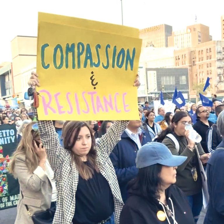 A woman holds a sign for the demonstration named “Do Not Be Afraid: March and Vigil” organized by the Diocese of El Paso to protest anti-migration bills and legal attacks on shelters. 