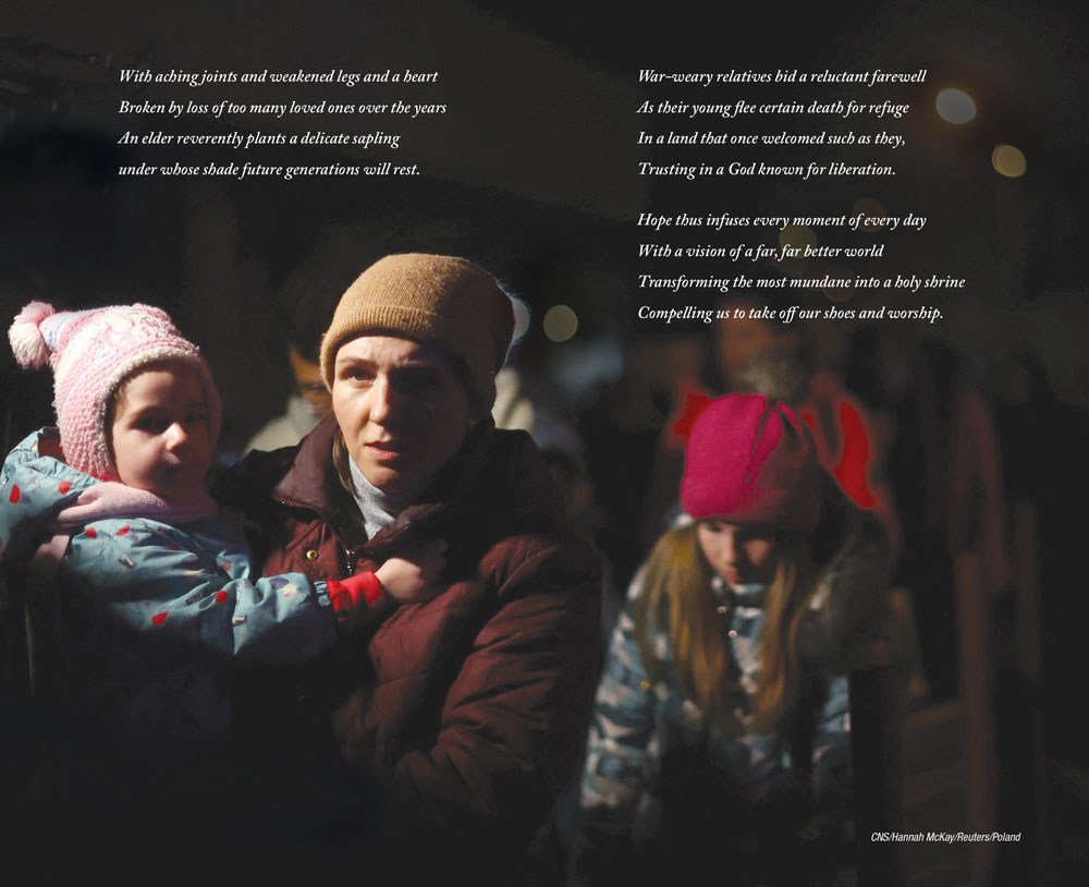 A mother walks holding one child and alongside another through the cold night.