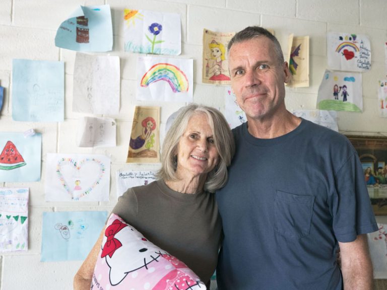 The Cunninghams display artwork made by the children in their full-time ministry at the El Patronato Lidia Coggiola community center in Zaragoza. 