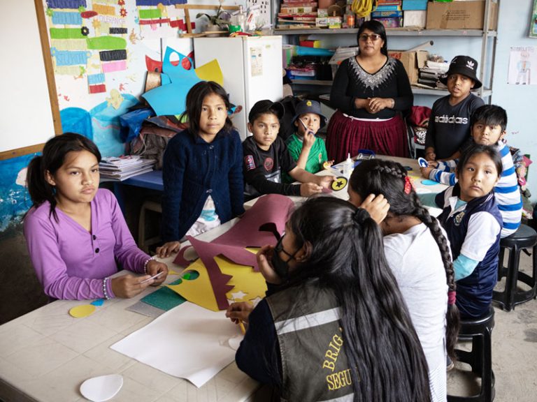 Facilitator Sabina Mamani Ortega (standing) leads an afterschool session at Tikuna Wasi, a tutoring center built for a marginalized community by the Maryknoll Fathers and Brothers as part of the Apoyo Escolar program. 