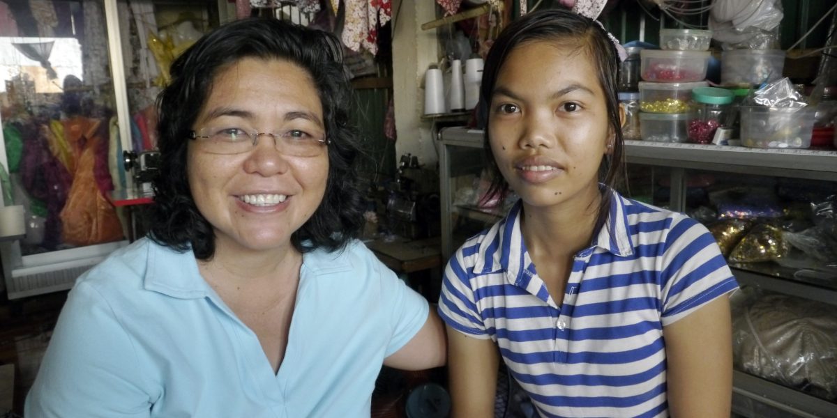 In Cambodia’s Kandal province, Maryknoll Sister Leonor Montiel visits a young woman who was given work as a seamstress as well as a bicycle through Maryknoll’s Seedling of Hope program. (Sean Sprague/Cambodia)
