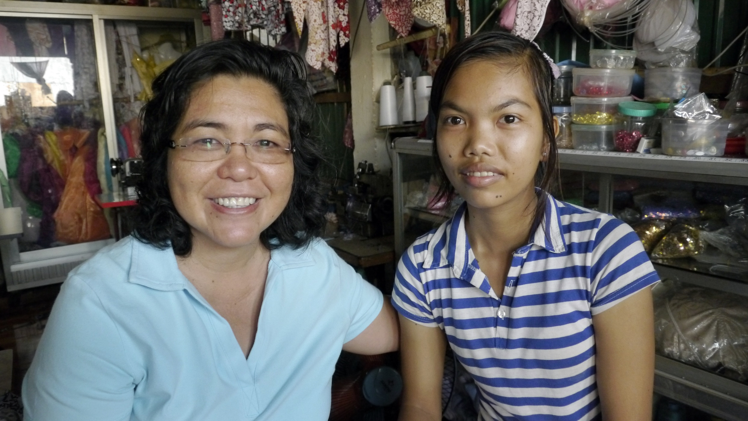 In Cambodia’s Kandal province, Maryknoll Sister Leonor Montiel visits a young woman who was given work as a seamstress as well as a bicycle through Maryknoll’s Seedling of Hope program. (Sean Sprague/Cambodia)