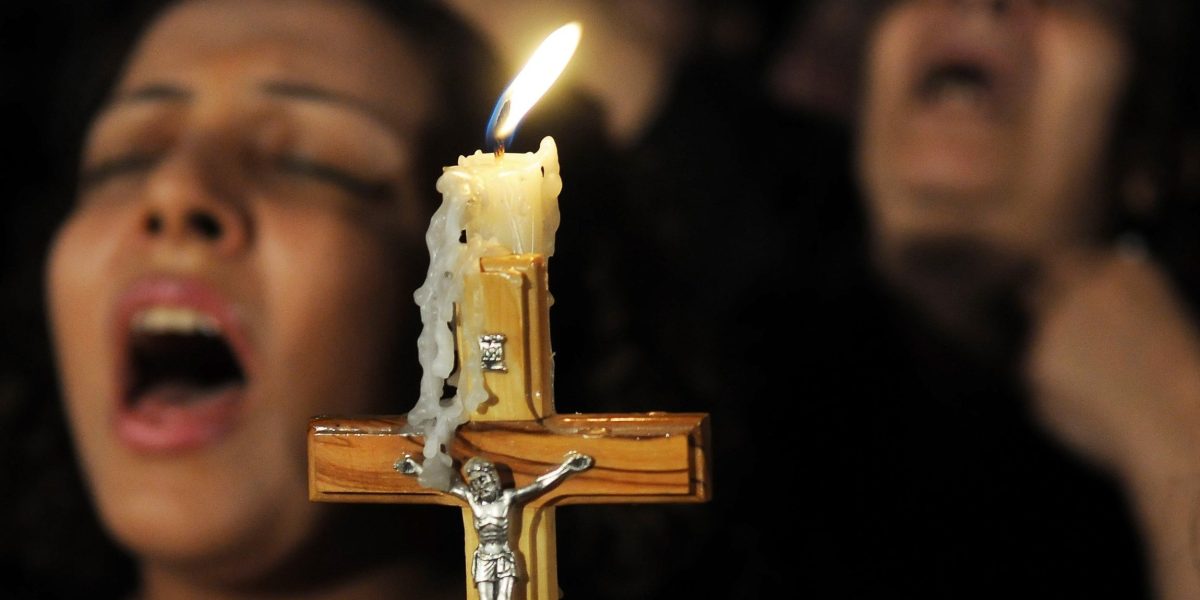 A crucifix is pictured in a file photo as Coptic Christians pray in Cairo. In the Coptic Orthodox Archdiocese of South Africa, three Egyptian Coptic monks were brutally murdered March 12, 2024, in their monastery in Cullinan, a small town about 18 miles east of the capital, Pretoria. (OSV News photo/stringer via Reuters)