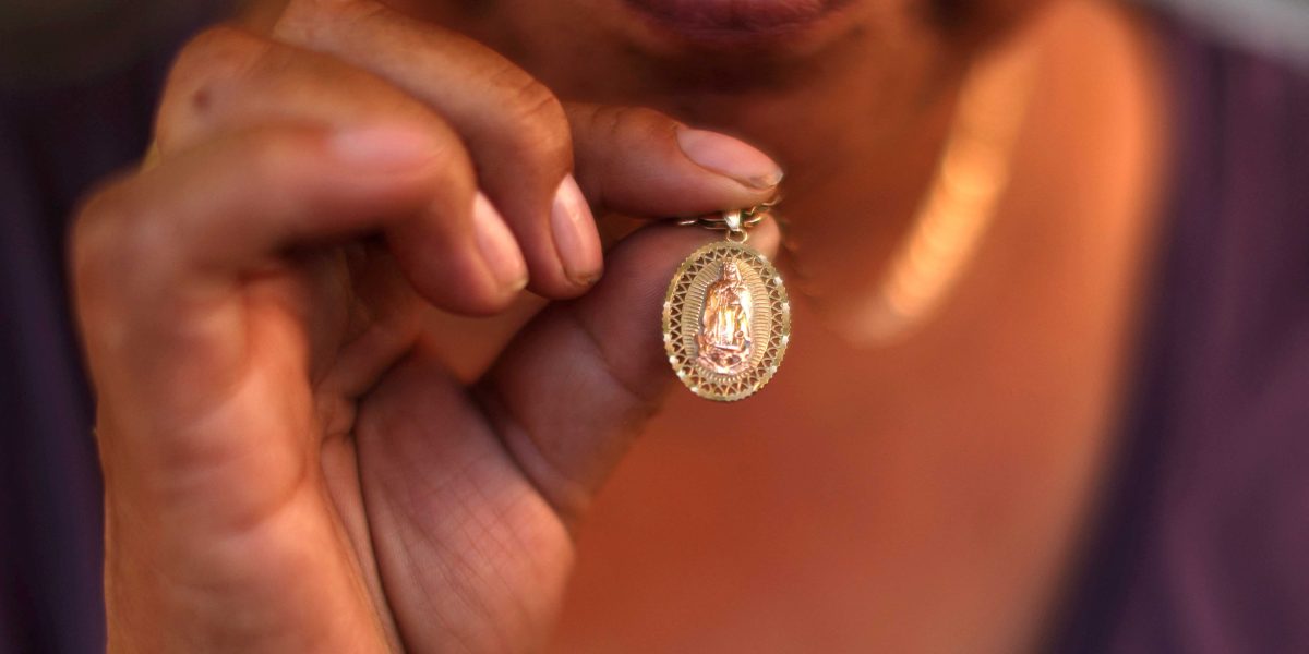 A Guatemalan woman shows her Our Lady of Guadalupe medal in Los Angeles, June 16, 2025, that she has been keeping since the immigration sweeps began. In the neighboring Diocese of San Bernardino, Calif., Bishop Alberto Rojas on July 8 dispensed the faithful in his diocese from the obligation to attend Sunday Mass if they fear for their well-being amid raids by U.S. Immigration and Customs Enforcement. (OSV News/Pilar Olivares, Reuters)