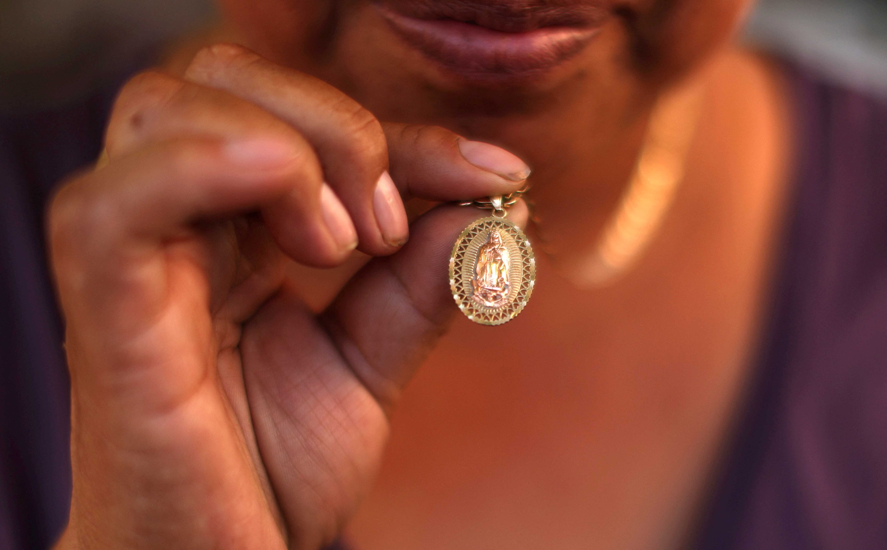 A Guatemalan woman shows her Our Lady of Guadalupe medal in Los Angeles, June 16, 2025, that she has been keeping since the immigration sweeps began. In the neighboring Diocese of San Bernardino, Calif., Bishop Alberto Rojas on July 8 dispensed the faithful in his diocese from the obligation to attend Sunday Mass if they fear for their well-being amid raids by U.S. Immigration and Customs Enforcement. (OSV News/Pilar Olivares, Reuters)