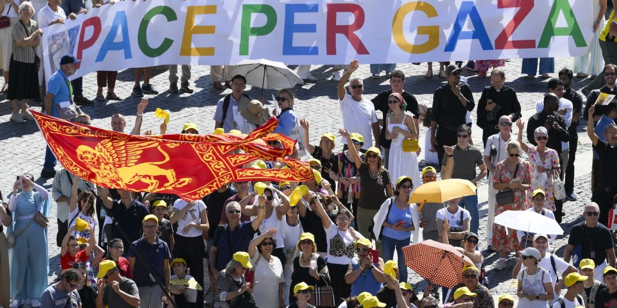 Visitors in St. Peter’s Square at the Vatican hold up a banner saying, “Peace for Gaza,” as they recite the Angelus prayer with Pope Leo XIV Sept. 21, 2025. (CNS photo/Vatican Media)