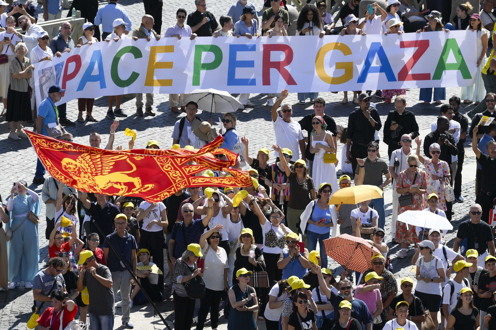 Visitors in St. Peter’s Square at the Vatican hold up a banner saying, “Peace for Gaza,” as they recite the Angelus prayer with Pope Leo XIV Sept. 21, 2025. (CNS photo/Vatican Media)