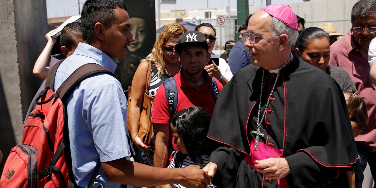 Bishop Mark J. Seitz of El Paso, Texas, greets a Salvadoran migrant in Ciudad Juarez, Mexico, June 27, 2019, who was deported from the U.S. after crossing the Paso del Norte international border from El Paso. (OSV News/Jose Luis Gonzalez, Reuters)