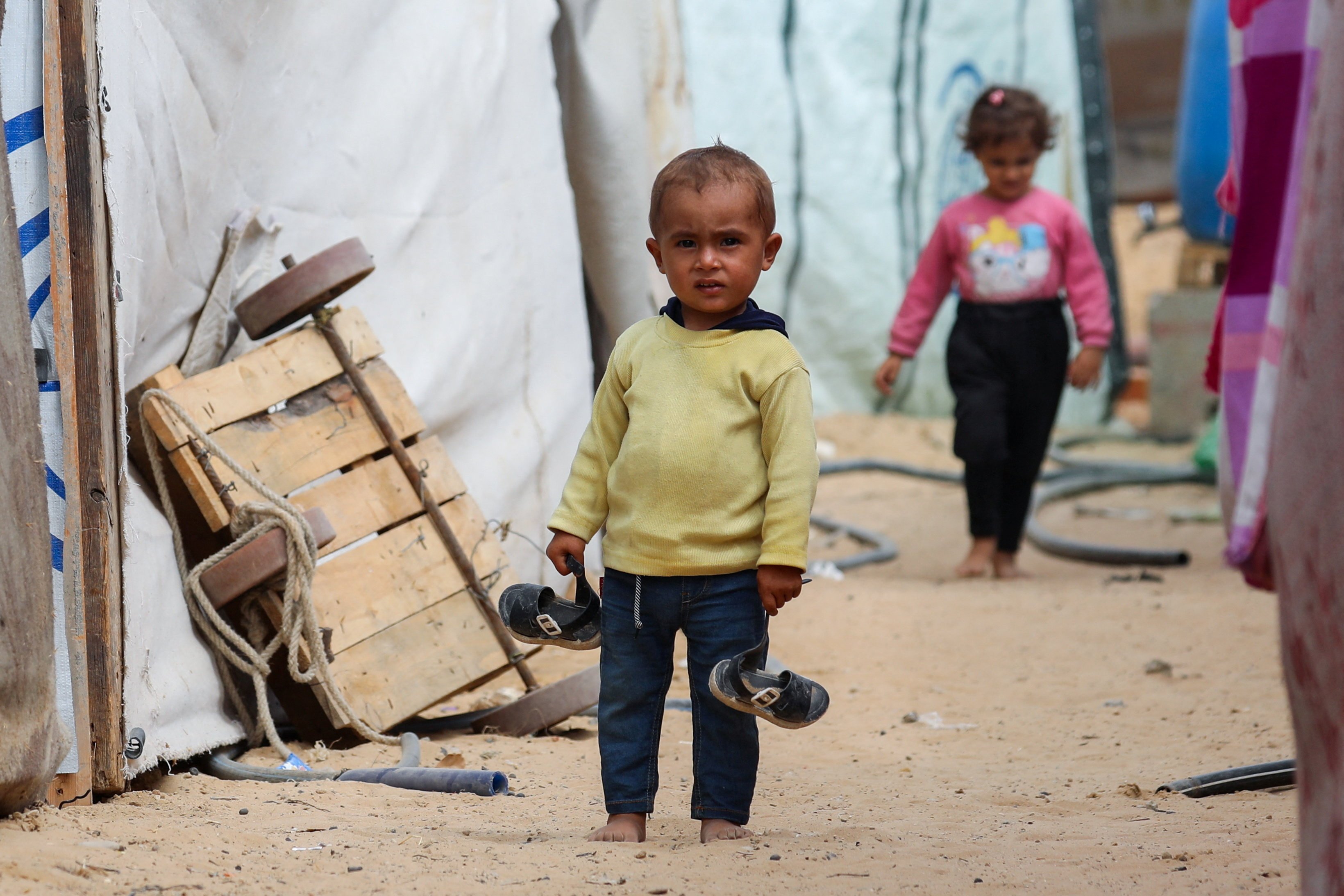 A Palestinian child stands between tents Oct. 6, 2025, where displaced Palestinians, who fled northern Gaza due to an Israeli military operation, shelter in the central Gaza Strip. (OSV News/Dawoud Abu Alkas, Reuters)
