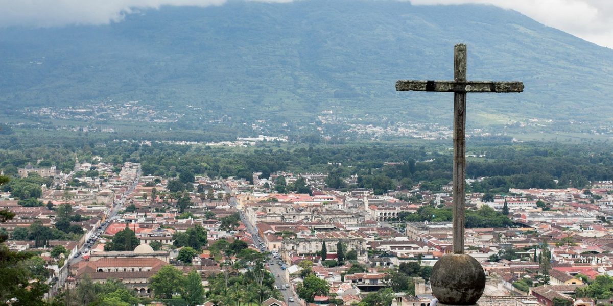 A cross overlooks the city of Antigua, Guatemala. (codyvanscyoc via Pixabay/Guatemala)
