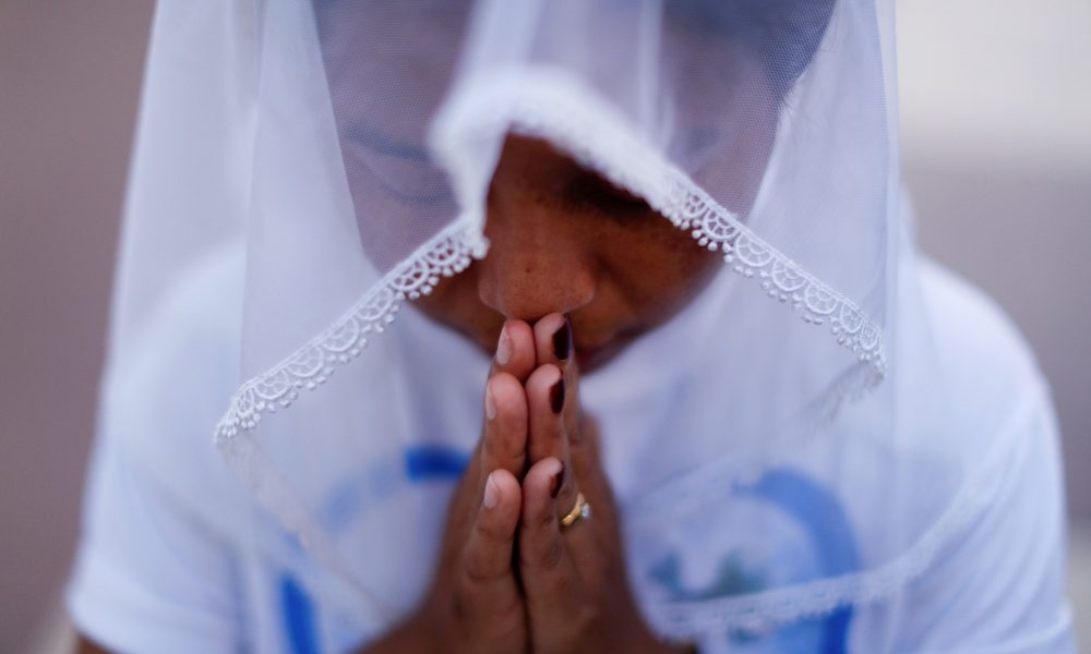 A woman is pictured in a file photo praying at St. Anthony Church in Yangon, Myanmar. Myanmar’s military is continuing to target churches in predominantly Christian regions in the Buddhist-majority country, ignoring appeals by the Catholic Church and world leaders, reports ucanews.com. (CNS/Jorge Silva, Reuters)