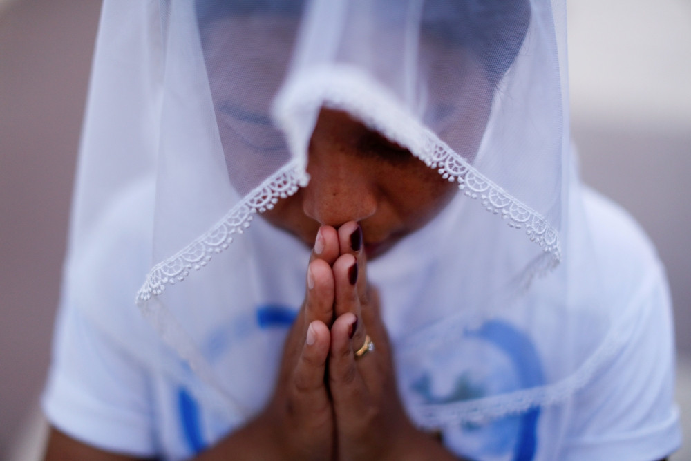 A woman is pictured in a file photo praying at St. Anthony Church in Yangon, Myanmar. Myanmar’s military is continuing to target churches in predominantly Christian regions in the Buddhist-majority country, ignoring appeals by the Catholic Church and world leaders, reports ucanews.com. (CNS/Jorge Silva, Reuters)