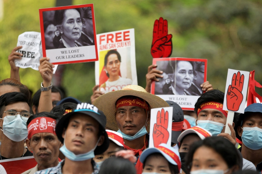 Demonstrators hold placards with pictures of ousted Myanmar leader Aung San Suu Kyi as they protest against the military coup in Yangon, Myanmar, Feb. 22, 2021. Anti-coup protesters face ongoing threats of arbitrary arrest, torture, and deadly attacks from the junta, said a new report. (CNS/Reuters)