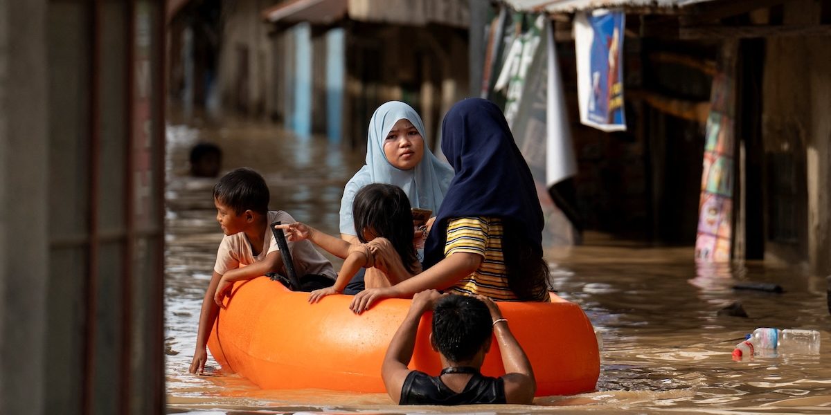 People ride on a rescue boat along a flooded street in Nueva Ecija, Philippines, Nov. 18, 2024, following Super Typhoon Man-yi. Man-yi left at least seven people dead in a landslide, destroyed houses and displaced large numbers of villagers before blowing away from the northern Philippines, worsening a crisis brought about by multiple back-to-back storms, officials said. (OSV News photo/Lisa Marie David, Reuters)