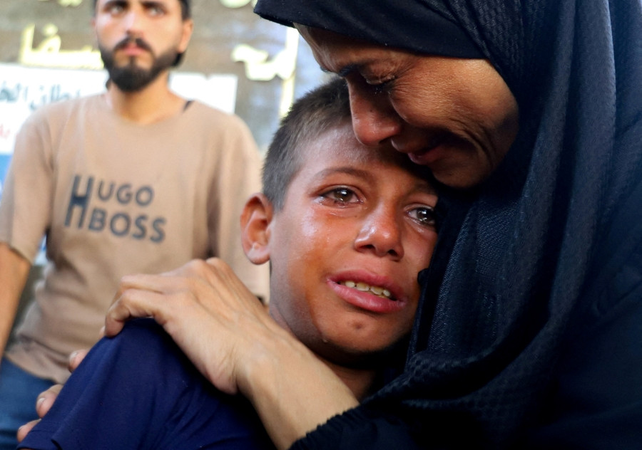 A boy cries during the Aug. 14, 2025, funeral of Palestinians killed in an Israeli airstrike while seeking aid in Gaza City, Gaza Strip, according to medics. (OSV News/Ebrahim Hajjaj, Reuters)