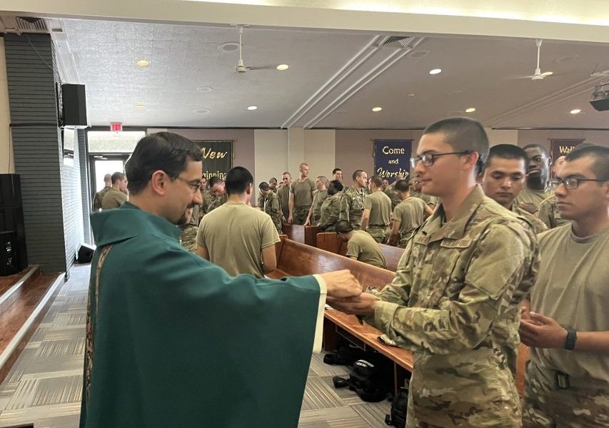 Father Rodrigo Ulloa, director of vocations for the Maryknoll Society since 2020, distributes Communion. Father Ulloa, who emigrated from Guatemala with his family in 1999, began to discover his priestly vocation during a deployment flight to the United Arab Emirates in 2001, while he was a member of the Air Force. (OSV News/Courtesy of Father Rodrigo Ulloa)