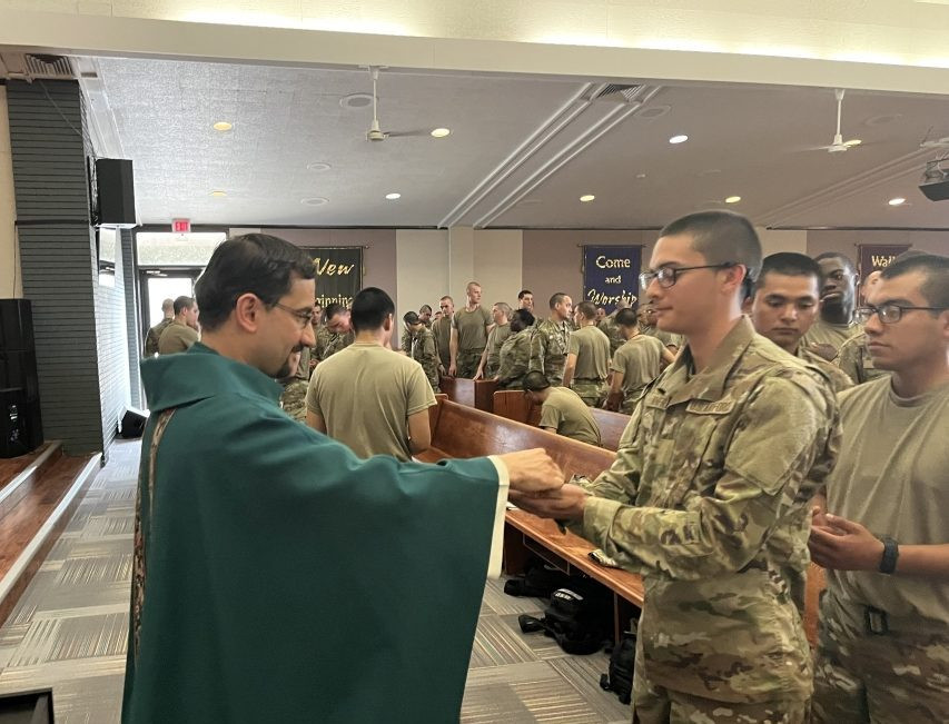 Father Rodrigo Ulloa, director of vocations for the Maryknoll Society since 2020, distributes Communion. Father Ulloa, who emigrated from Guatemala with his family in 1999, began to discover his priestly vocation during a deployment flight to the United Arab Emirates in 2001, while he was a member of the Air Force. (OSV News/Courtesy of Father Rodrigo Ulloa)