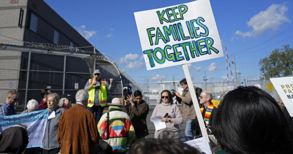 People gather for a pro-immigrant prayer vigil outside Delaney Hall, a migrant detention center in Newark, N.J., Oct. 22, 2025. The event was affiliated with the nationwide “One Church, One Family: Catholic Public Witness for Immigrants” initiative that had been organized in response to the Trump administration’s continuing crackdown on unauthorized immigration. A similar event is scheduled for Nov. 13, the feast of St. Frances Xavier Cabrini, patroness of immigrants. (OSV News/Gregory A. Shemitz)