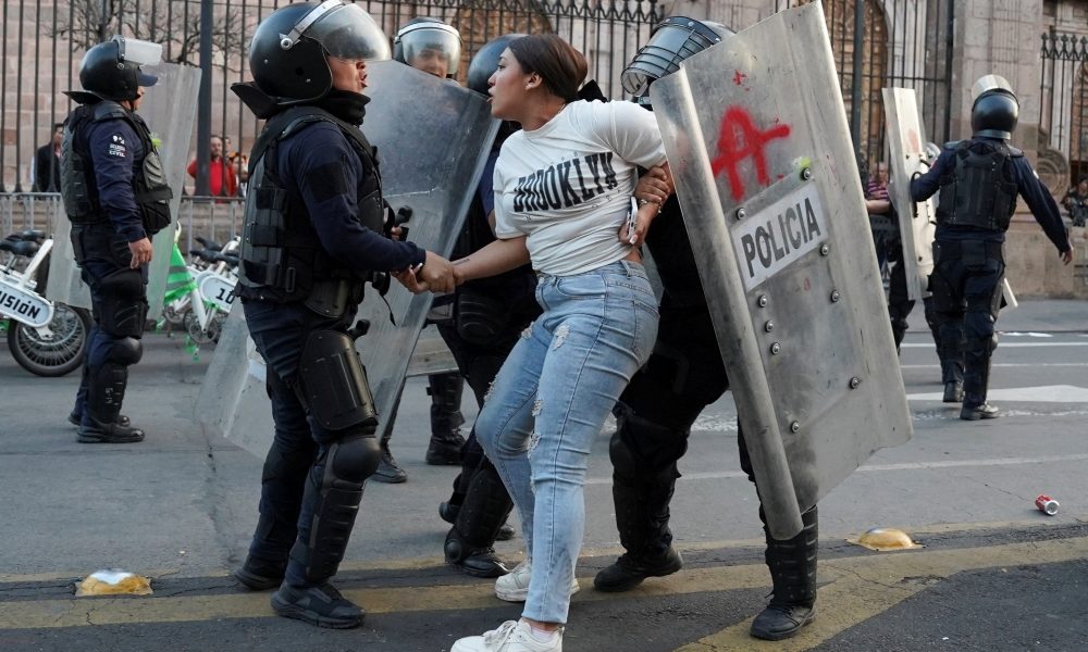Riot police officers detain a woman during a demonstration in Morelia, Mexico, Nov. 2, 2025, over the assassination of Uruapan Mayor Carlos Manzo. Manzo was assassinated Nov. 1 in a plaza in front of dozens of people who had gathered for Day of the Dead festivities, authorities said. (OSV News/Asaid Castro, Reuters)