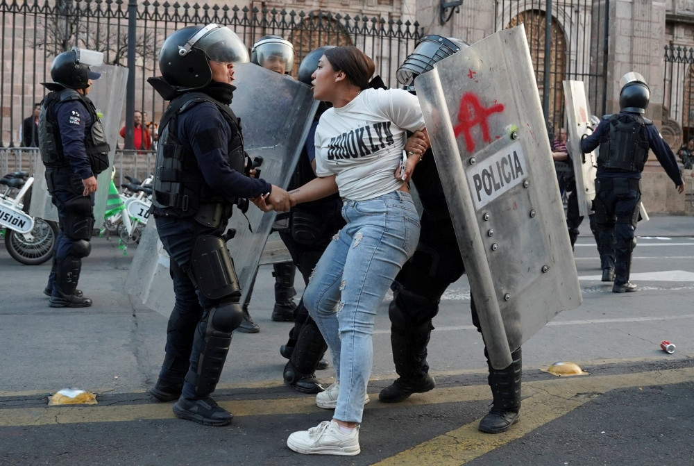 Riot police officers detain a woman during a demonstration in Morelia, Mexico, Nov. 2, 2025, over the assassination of Uruapan Mayor Carlos Manzo. Manzo was assassinated Nov. 1 in a plaza in front of dozens of people who had gathered for Day of the Dead festivities, authorities said. (OSV News/Asaid Castro, Reuters)