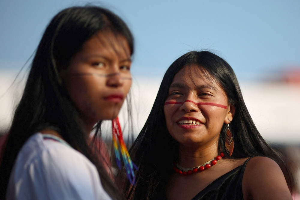Women look on after a flotilla carrying Indigenous representatives from across Latin America arrived in Belem Nov. 9, 2025, ahead of the U.N. Climate Change Conference, or COP30, in Brazil. A delegation of cardinals, bishops and lay activists gives the Brazil church a strong presence at COP30, taking place Nov. 10-21 in Belém. (OSV News/Adriano Machado, Reuters)