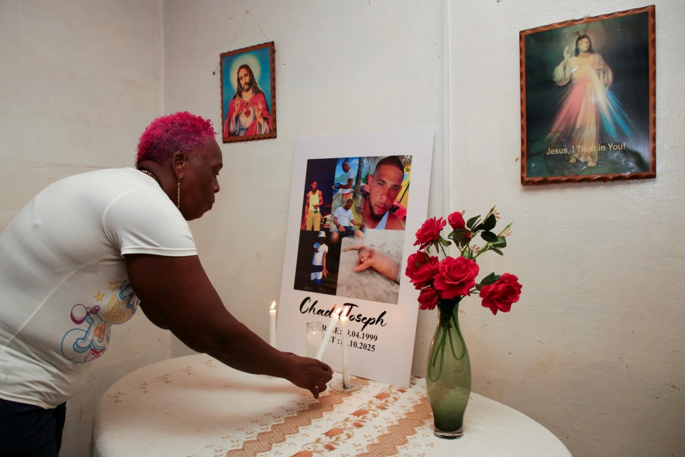 Lynette Burnley, aunt of Chad Joseph, who family members believe was killed in a U.S. military strike on a boat in the Caribbean, lights a candle at an altar for Joseph in the family home in Las Cuevas, Trinidad and Tobago, Oct. 22, 2025. (OSV News/Andrea de Silva, Reuters)