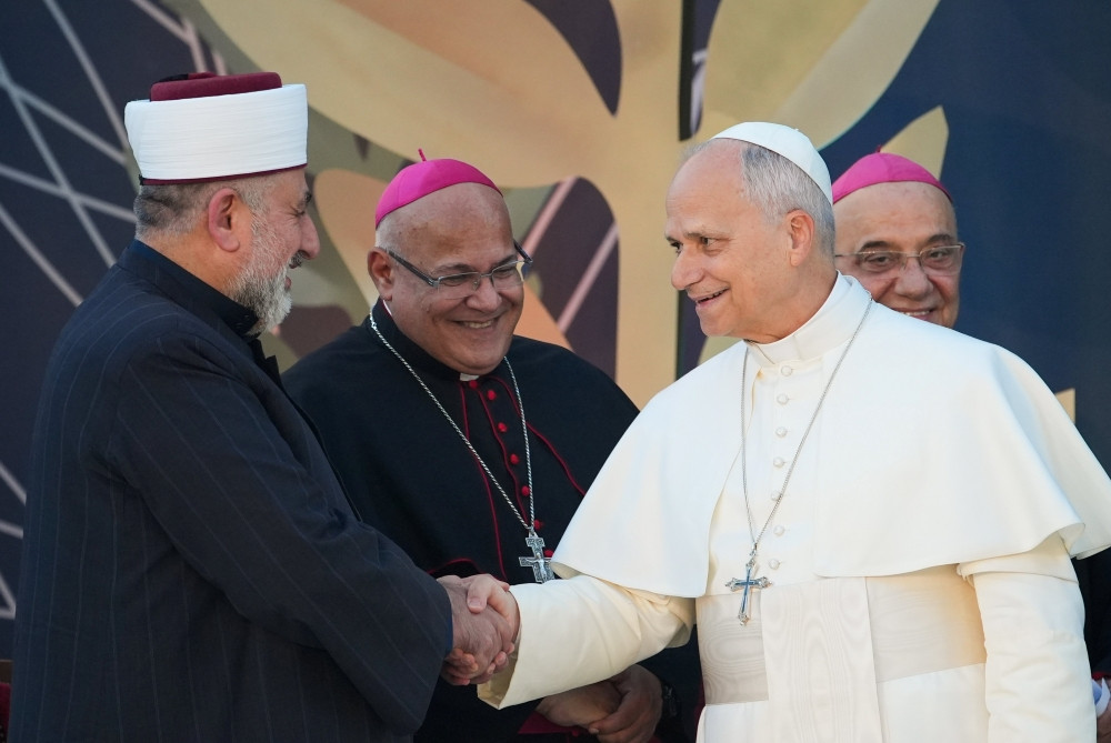 Pope Leo XIV shakes hands with Sheikh Ali Kaddour, head of the Alawi Islamic Council in Lebanon during an ecumenical and interreligious meeting in Martyrs’ Square in Beirut, Lebanon, Dec. 1, 2025. (CNS/Lola Gomez)