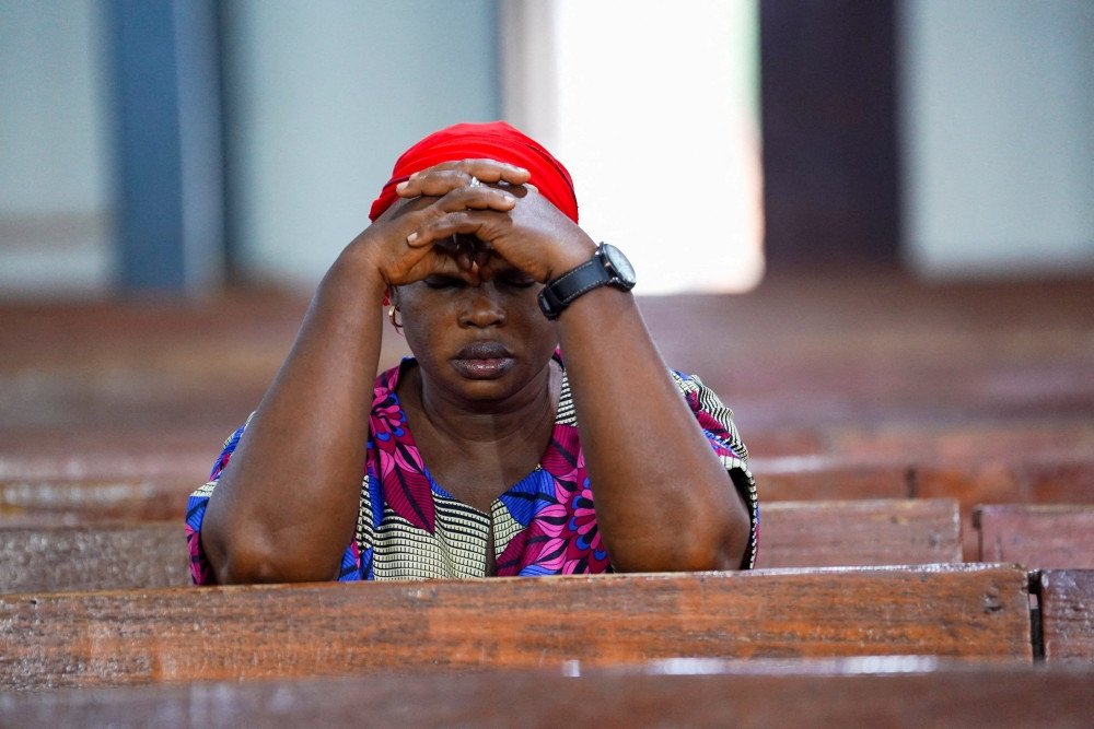 A woman prays during evening Mass at St. Michael Cathedral in Minna, Nigeria, Dec. 4, 2025. (OSV News/Marvellous Durowaiye, Reuters)