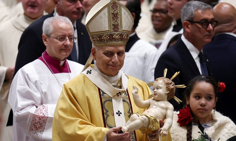 Pope Leo XIV holds a figurine of baby Jesus during Christmas Eve Mass in St. Peter’s Basilica at the Vatican Dec. 24, 2025. (OSV News/Guglielmo Mangiapane)