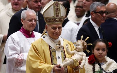 Pope Leo XIV holds a figurine of baby Jesus during Christmas Eve Mass in St. Peter’s Basilica at the Vatican Dec. 24, 2025. (OSV News/Guglielmo Mangiapane)