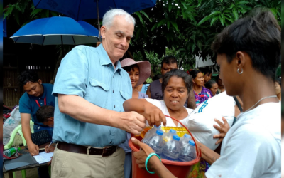 Maryknoll Father John Barth distributes food and water to survivors of an earthquake in Myanmar earlier this year. Father Barth managed funds raised by the Maryknoll Society to bring relief to survivors through the Diocese of Mandalay. (Courtesy of John Barth/Myanmar)