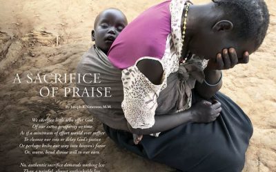 A woman sits on the ground in despair with a baby sleeping peacefully in a wrap on her back.