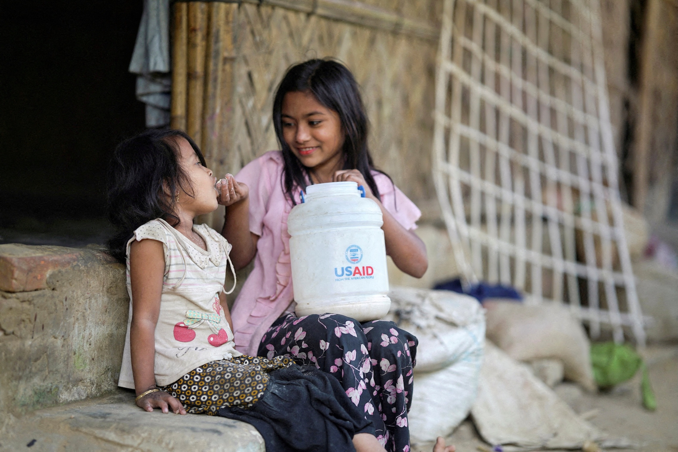 Rohingya children eat from a jar with the USAID logo at a refugee camp in Cox’s Bazar, Bangladesh, on Feb. 11, 2025. (OSV News/Ro Yassin Abdumonab/Reuters/Bangladesh)