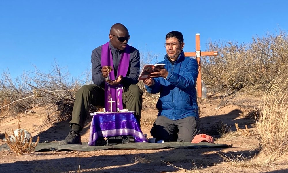 Two unidentified Jesuit priests concelebrate Mass in the Chihuahuan Desert in New Mexico Dec. 21, 2025, for a 20-year-old Guatemalan woman, whose remains were previously recovered in the area marked by the cross, and also for two women whose remains were found Dec 19. (OSV News/courtesy Collin Price)
