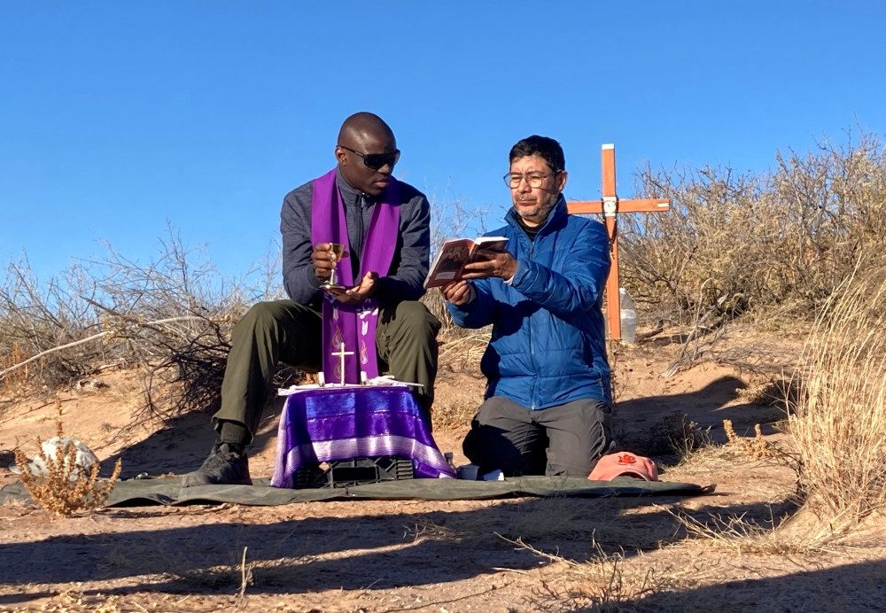 Two unidentified Jesuit priests concelebrate Mass in the Chihuahuan Desert in New Mexico Dec. 21, 2025, for a 20-year-old Guatemalan woman, whose remains were previously recovered in the area marked by the cross, and also for two women whose remains were found Dec 19. (OSV News/courtesy Collin Price)