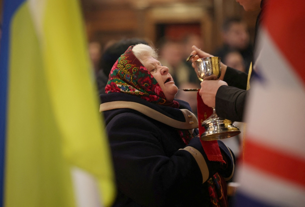 A woman receives Communion during the Divine Liturgy at the Ukrainian Catholic Church in London Dec. 28, 2025, on the day Ukrainian President Volodymyr Zelenskyy meets U.S. President Donald Trump in Florida to work out a deal to end nearly four years of war since Russia’s full-scale invasion of Ukraine. The liturgy was celebrated on the feast of the Holy Family. (OSV News/Isabel Infantes, Reuters)
