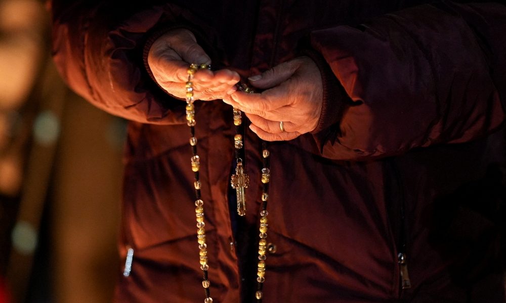 A woman holds a rosary during a vigil for a 37-year-old woman who was shot in her car by a U.S. immigration agent, according to local and federal officials, in Minneapolis Jan. 7, 2026. (OSV News/Tim Evans, Reuters)