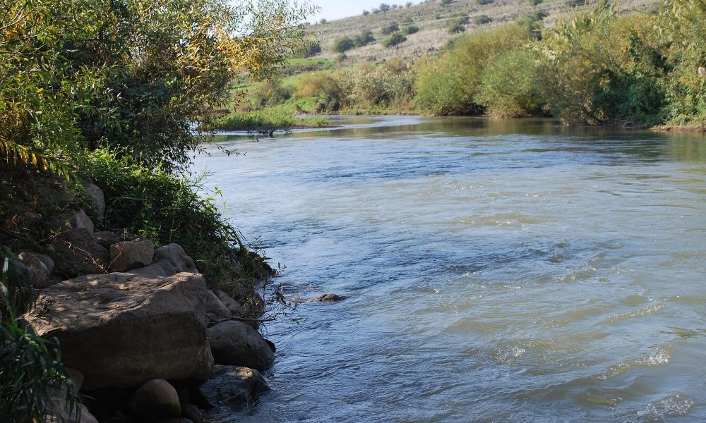 A photo shows the Jordan River, where Jesus was baptized by John the Baptist. (Bill Rice via Wikimedia commons, CC BY-SA 4.0).